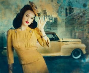 A Vintage Moment depicts stylish woman in yellow dress in front of 1930's car.